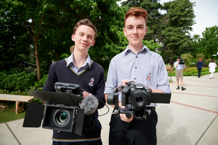 Picture of a student holding a camera rig.